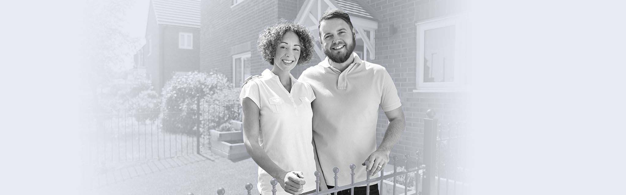 Couple in front of their house